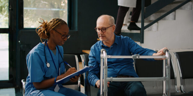 female nurse doing checkup consultation with old patient